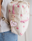 prote-cles-charms-de-sac-rayure-rose-blanc-en-metal-dore-milinane